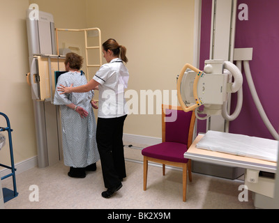 Radiographer Getting Ready To Take An X-Ray Of Elderly Woman's Chest England Stock Photo