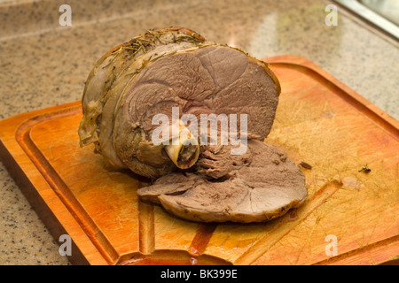 Roast lamb on a cutting board ready to carve Stock Photo