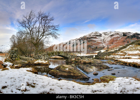 Slaters Bridge, Little Langdale, River Brathay, Lake District National Park, UK, Winter, snow on the ground. Stock Photo