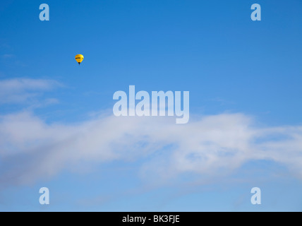 Tiny yellow hot air balloon on blue sky , Finland Stock Photo