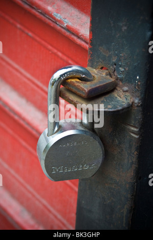 Large master padl;ock on commercial store front security gate. Stock Photo