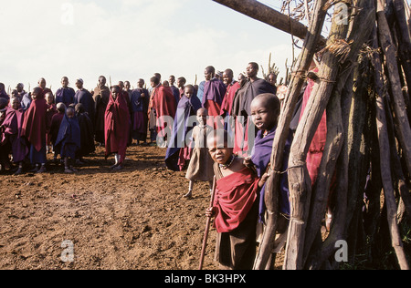 Children and adults in a Maasai village near the border of Tanzania and Kenya Stock Photo