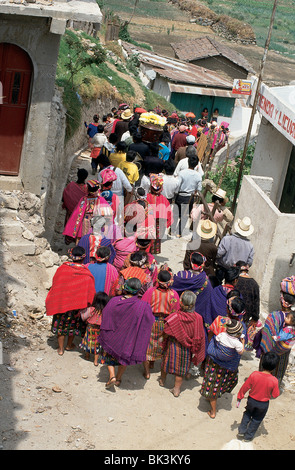 Indigenous people wearing traditional clothing carrying a coffin in a funeral procession in the city of Cantel, Quetzaltenango Department, Guatemala Stock Photo