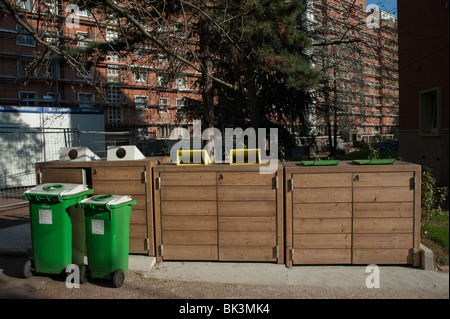 Recycling Garbage Rubbish Bins Trash Cans, wheely bin , outside Apartment Building,  green waste paris, recycling bin france, social housing, waste bins in front of building, sustainable urban planning Stock Photo