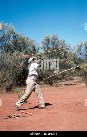An Aborigine man using a throwing sling with a spear in Rod Steinert's Aboriginal Dreamtime Tour, Australia Stock Photo