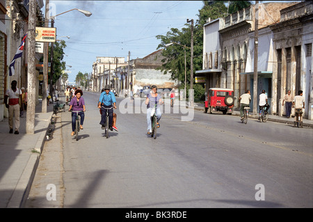 Street scene with people riding bicycles in Cardenas, Cuba Stock Photo