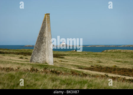 Skerries Lighthouse from Carmel Head from the Anglesey coastal path with Beacon pylon, North Wales Stock Photo