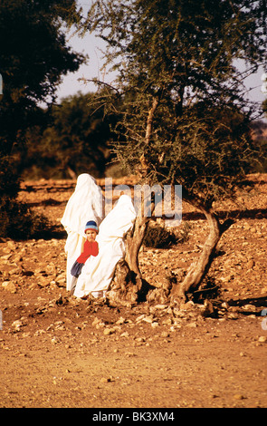 Full-length portrait of a child and two women wearing tradition hijab clothing near Marrakech, Morocco Stock Photo
