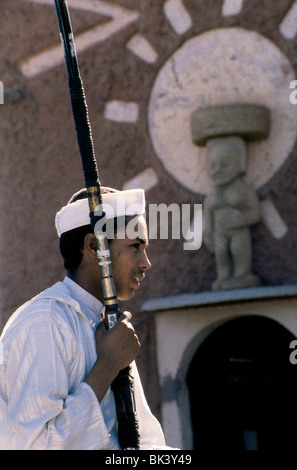 Profile of a young man holding guns Stock Photo - Alamy