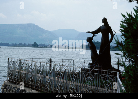 Statue of Jesus Feeding the Multitudes, The statue stands at Tabgha with Lake Tiberias (Sea of Galilee)in the background, Israel Stock Photo