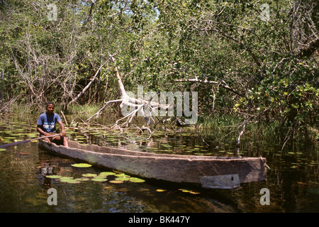 A boy sitting in a dugout canoe, Belize, Central America Stock Photo