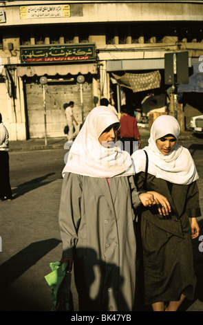 Two women wearing white headscarves, Amman, Jordan Stock Photo
