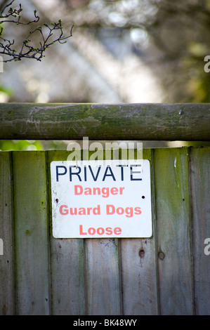 dog warning sign on wooden garden gate Stock Photo