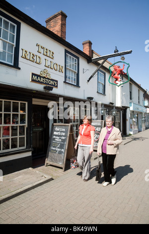 People walking past The Red Lion, a Marstons pub, High Street, Billericay, Essex UK Stock Photo