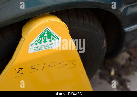 A DVLA clamp on a car wheel because the car had not been taxed. Stock Photo