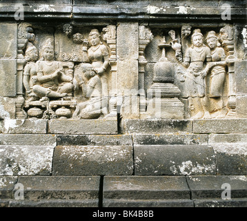 9th Century Stone relief carvings tell stories of Buddha's life at the Buddhist temple Borobudur in Central Java, Indonesia Stock Photo