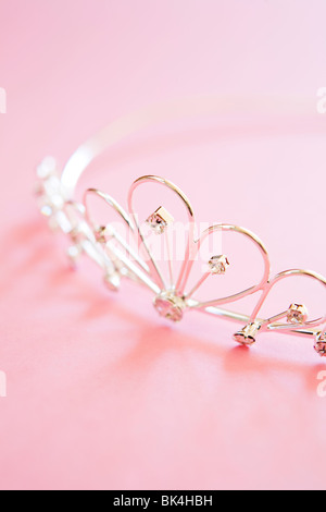 silver princess tiara often worn at weddings with jewels shot on pink background Stock Photo