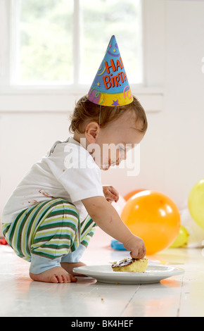 Boy eating cake on his first birthday Stock Photo