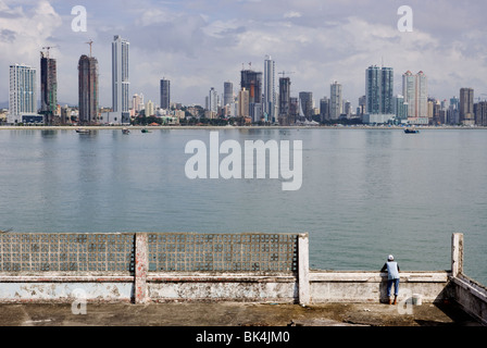 A person is looking at the construction of the new Panama City Skyline from the runes of the Antiguo Club Union Stock Photo