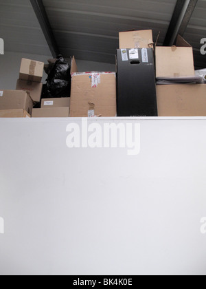 Collection of cardboard boxes on high ledge Stock Photo