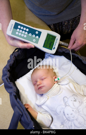 Newborn / new born baby undergoes a routine neonatal hearing screening test – Automated otoacoustic emissions test and passes. Stock Photo
