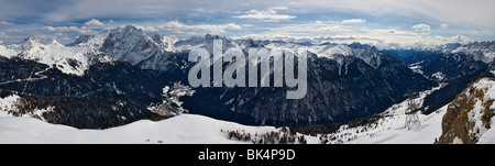 panoramic image of Dolomites mountains in winter, Italy, view of Val di Fassa with Marmolada glacier and peak, Belvedere ski are Stock Photo