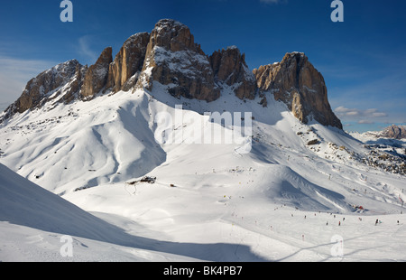 panoramic image of Dolomites mountains in winter, Italy, view of Sassolungo with Col Rodella ski area, Sella Ronda Stock Photo