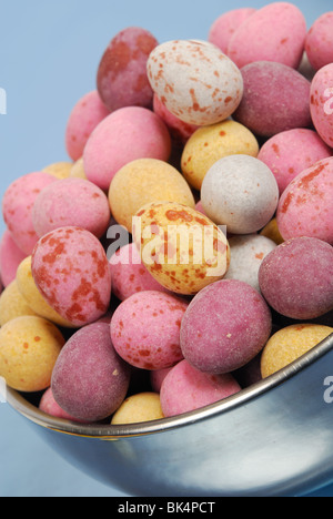 A bowl of mini candy-covered speckled chocolate Easter eggs.