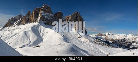 panoramic image of Dolomites mountains in winter, Italy, view of Sassolungo with Col Rodella ski area, Sella Ronda Stock Photo