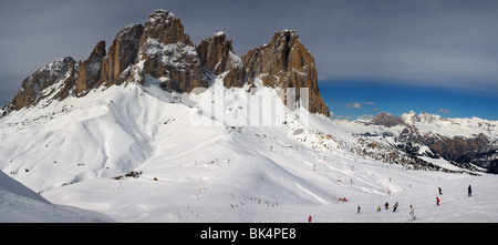 panoramic image of Dolomites mountains in winter, Italy, view of Sassolungo with Col Rodella ski area, Sella Ronda Stock Photo