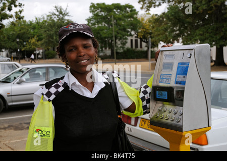 portrait of a smiling happy parking meter attendant with the payment machine in Stellenbosch town centre western Cape South Afri Stock Photo