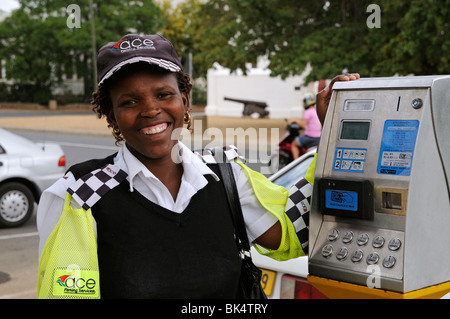 portrait of a smiling happy parking meter attendant with the payment machine in Stellenbosch town  western Cape South Africa Stock Photo