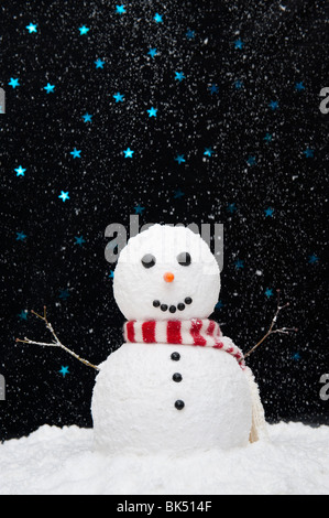 Snowman in the snow against starry night sky concept Stock Photo