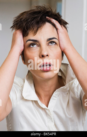 Woman Holding Her Head Stock Photo