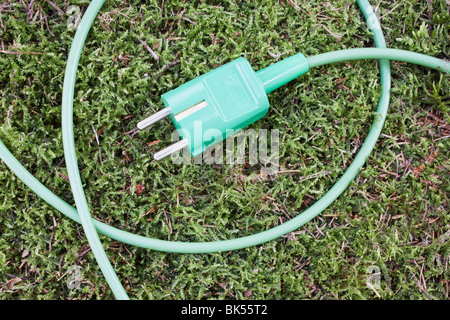 Electrical Plug on Grass Stock Photo