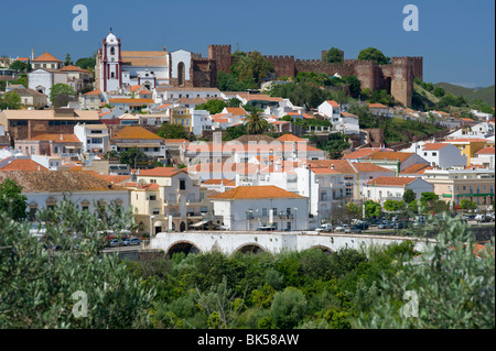 Portugal, The Algarve, Silves, Town And Castle Seen Over Orange Groves Stock Photo