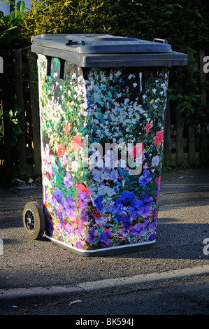 Hand decorated domestic  rubbish 'wheelie  bin' waiting outside house for refuse collection, Reading, Berkshire, United Kingdom Stock Photo