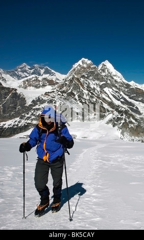 A climber walks towards advanced base campon Mera Peak, a popular trekking peak with Mount Everest beyond, Nepal Stock Photo