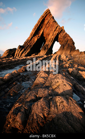 The light of the setting sun illuminates the unusual architecture of Blackchurch Rock, Culm Coast, North Devon, England Stock Photo