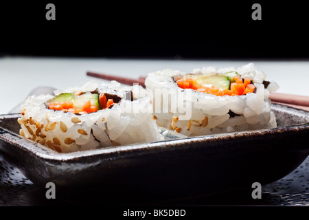 Vegetarian sushi California roll with rice and seaweed on Japanese plates Stock Photo