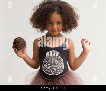 Girl with chocolate cupcake Stock Photo