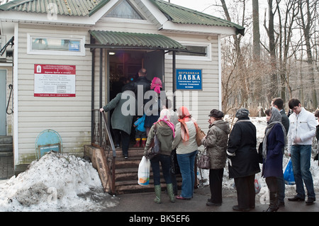 Turn from people in a church bench for Easter on a cemetery in Russia, St. Petersburg. Easter day Stock Photo