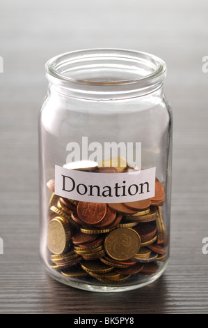 Coins in Donation Jar Stock Photo