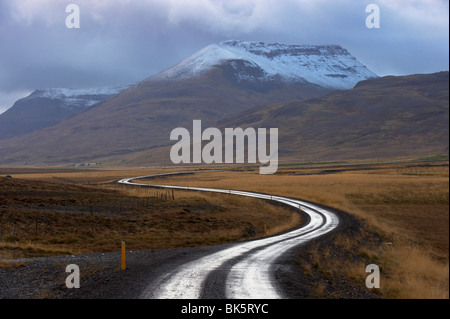 Road and landscape in Vatsnes Peninsula, with snow-covered mountains in October, north coast of Iceland, Iceland, Polar Regions Stock Photo
