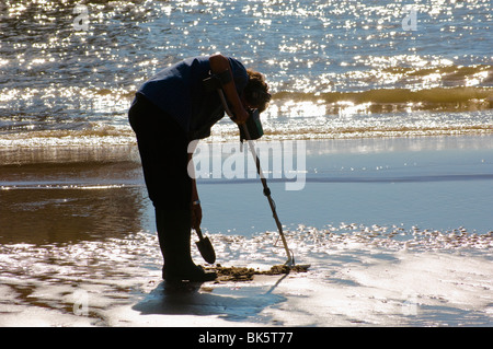 Man using metal detector on beach at Blackpool, England Stock Photo