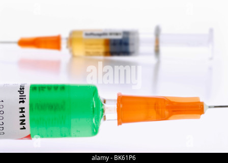 Two syringes with different vaccines against the swine flu Stock Photo