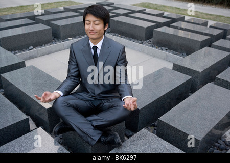 Businessman doing yoga Stock Photo