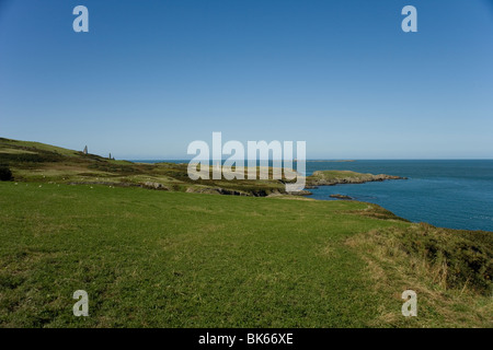 Skerries Lighthouse and Carmel Head and Beacons from the Anglesey coastal path, North Wales Stock Photo