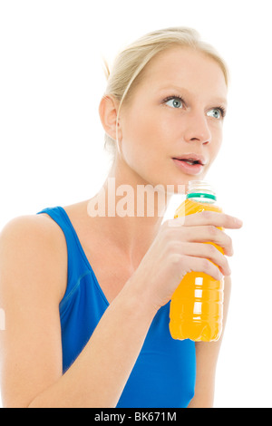 portrait of a young caucasian woman wearing a sports blue vest and drinks a bottle of energy drinks Stock Photo