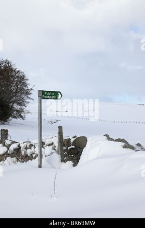 Snow Drifts and Public Footpath Sign Near High Force in Upper Teesdale County Durham Stock Photo